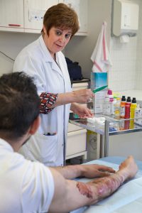 L'infirmière reçoit en salle de soin un patient qui s'est scarifié les bras pendant la nuit. L'infirmière reçoit en salle de soin un patient qui s'est scarifié les bras pendant la nuit. Avec patience elle nettoie les plaies et essaye de convaincre le détenu que l'automutilation n'est pas la solution à ses problèmes. ©Natacha Soury